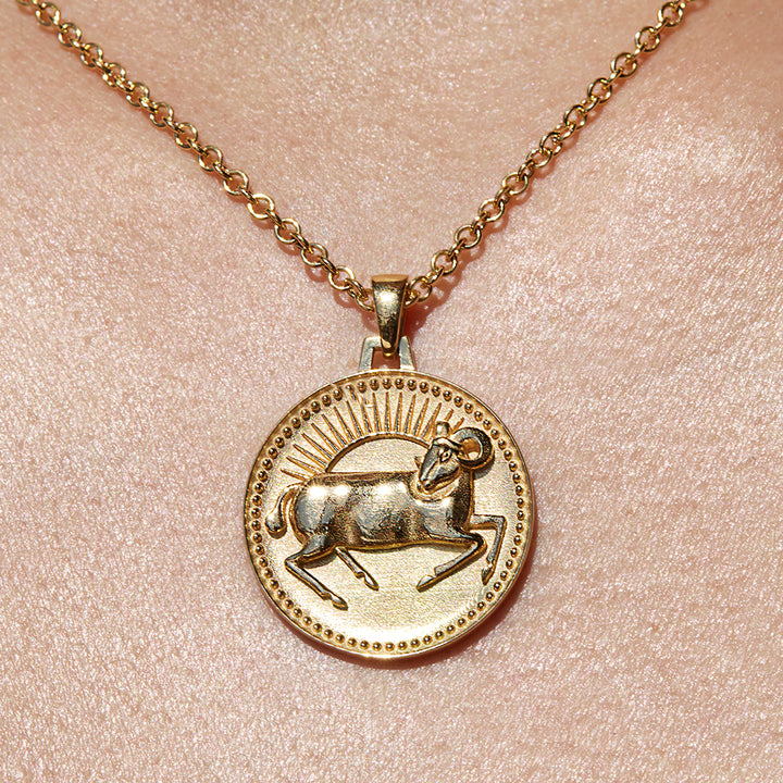 Close up of Aries Ethical Gold Pendant Necklace Being Worn Against Skin