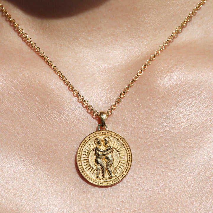 Close up of Gemini Ethical Gold Pendant Necklace Being Worn Against Skin