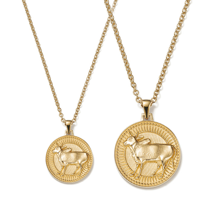 Small and Large Ethical Gold Taurus Pendant Necklaces Side By Side on a White Background
