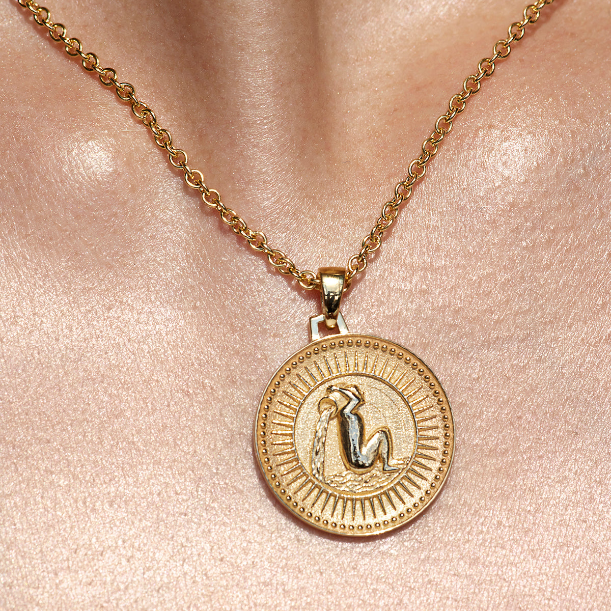 Close up of Aquarius Ethical Gold Pendant Necklace Being Worn Against Skin