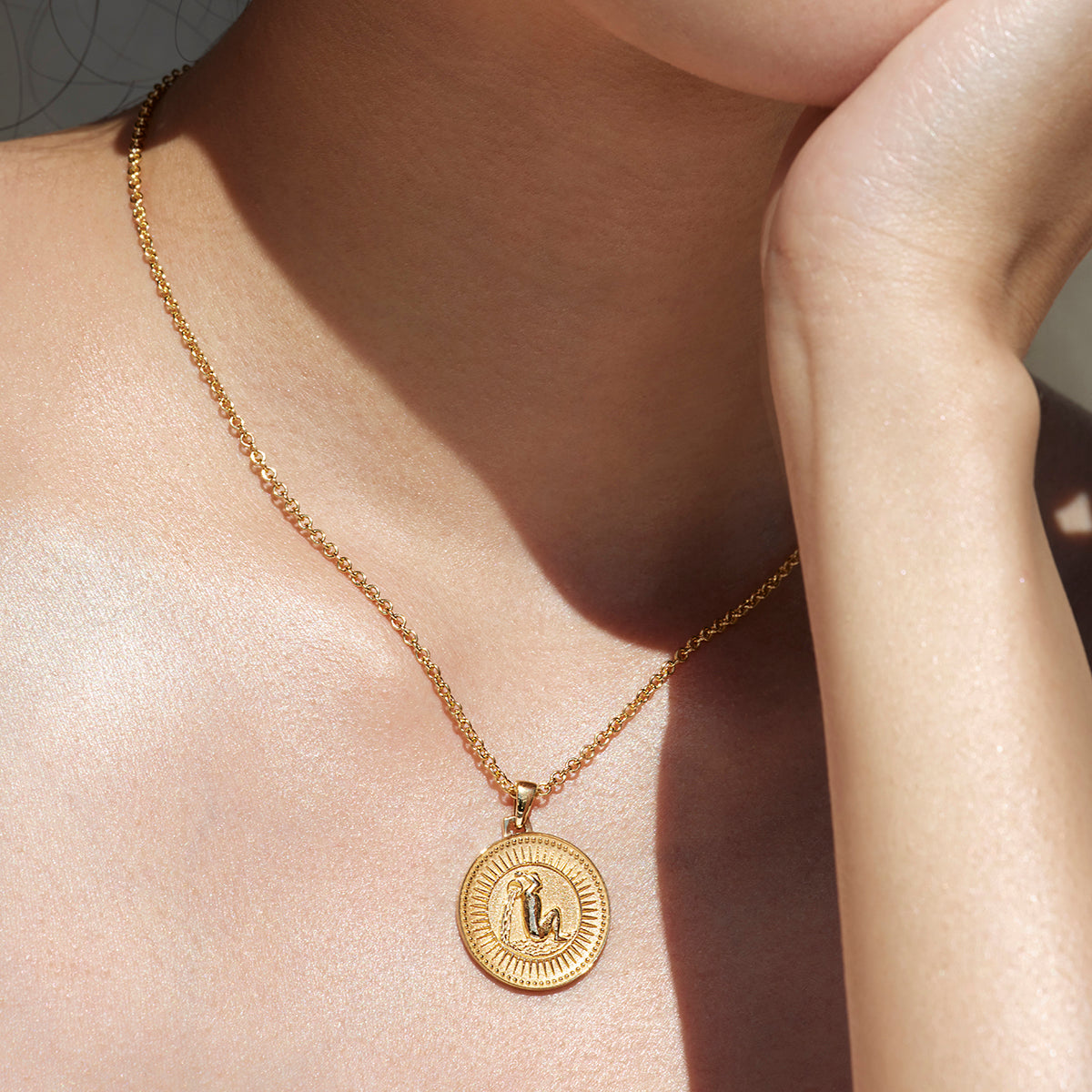 Ethical Gold Aquarius Pendant Necklace Worn Around a Woman's Neck 