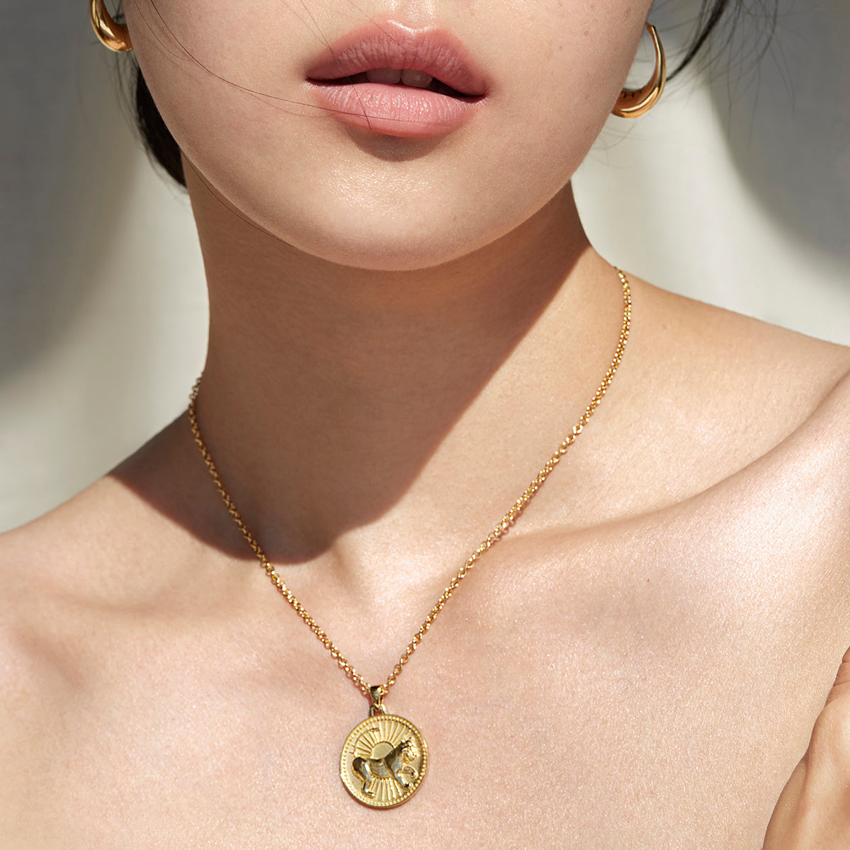 Woman from Lips to Shoulders Wearing Ethical Gold Leo Pendant Necklace
