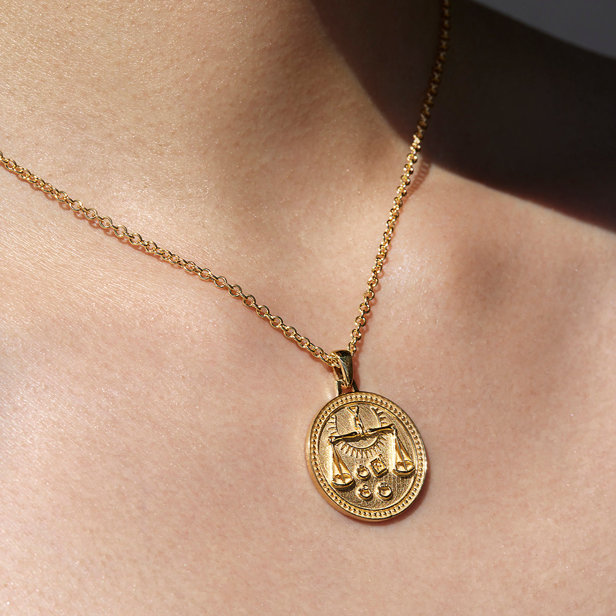 Close up of Libra Ethical Gold Pendant Necklace Being Worn Against Skin