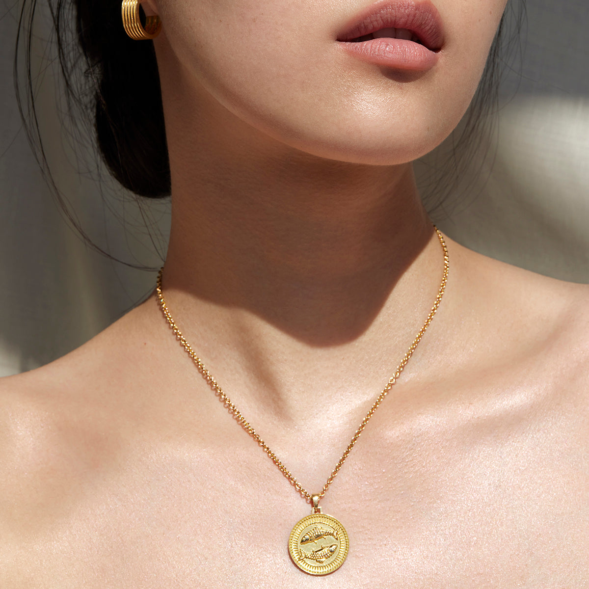 Woman from Lips to Shoulders Wearing Ethical Gold Pisces Pendant Necklace