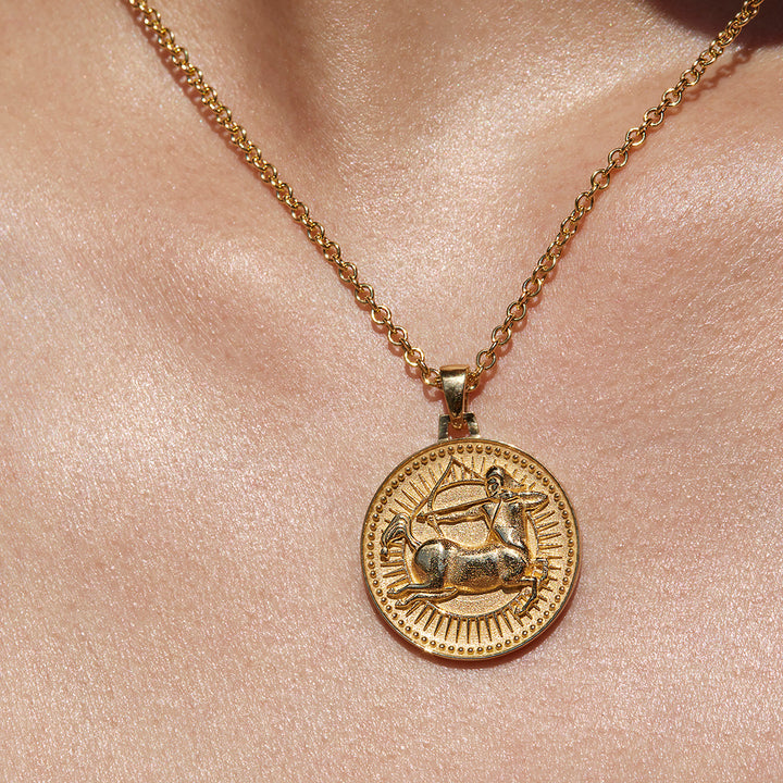 Close up of Sagittarius Ethical Gold Pendant Necklace Being Worn Against Skin