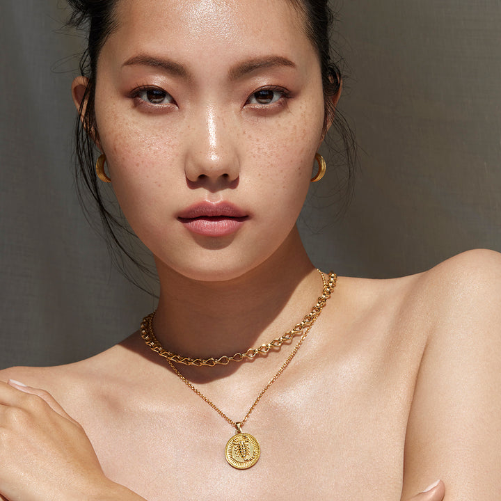 Woman Facing the Camera Wearing Scorpio Ethical Gold Pendant and Ethical Gold Chain 