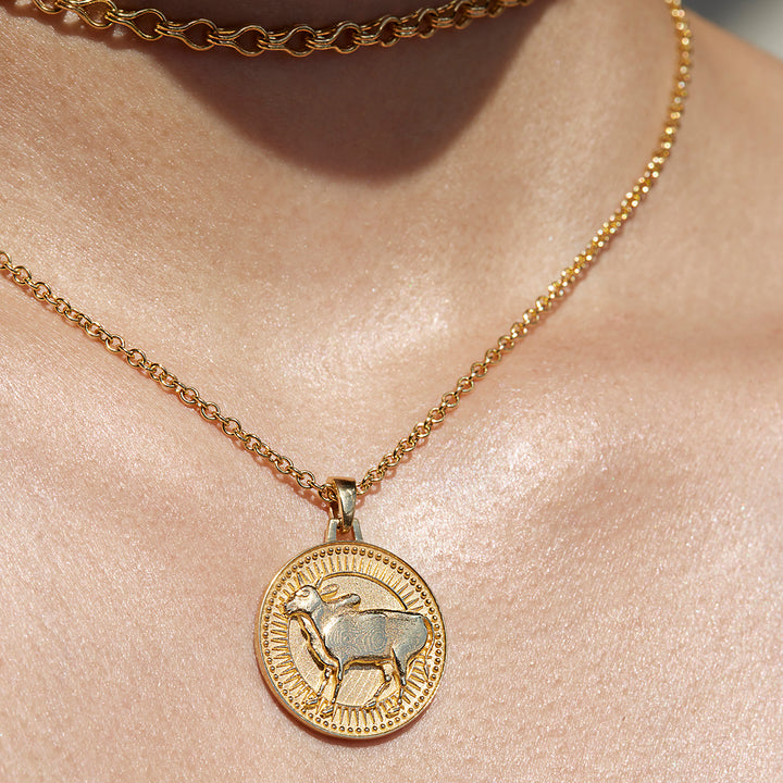 Close up of Taurus Ethical Gold Pendant Necklace Being Worn Against Skin